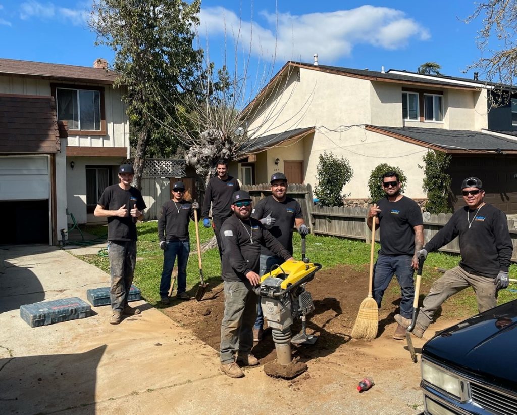 the Bailey Plumbing team working outside of a home
