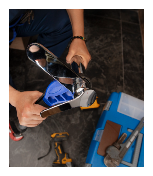 a plumber using a tool