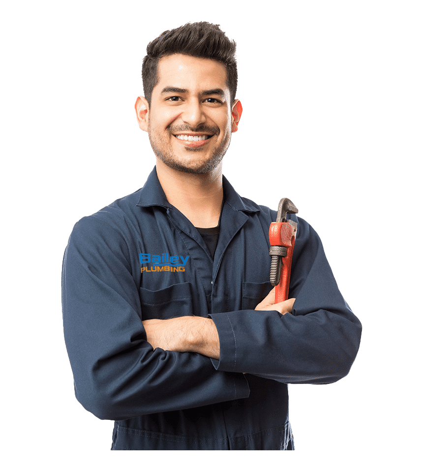 a Bailey Plumbing plumber smiling with a wrench
