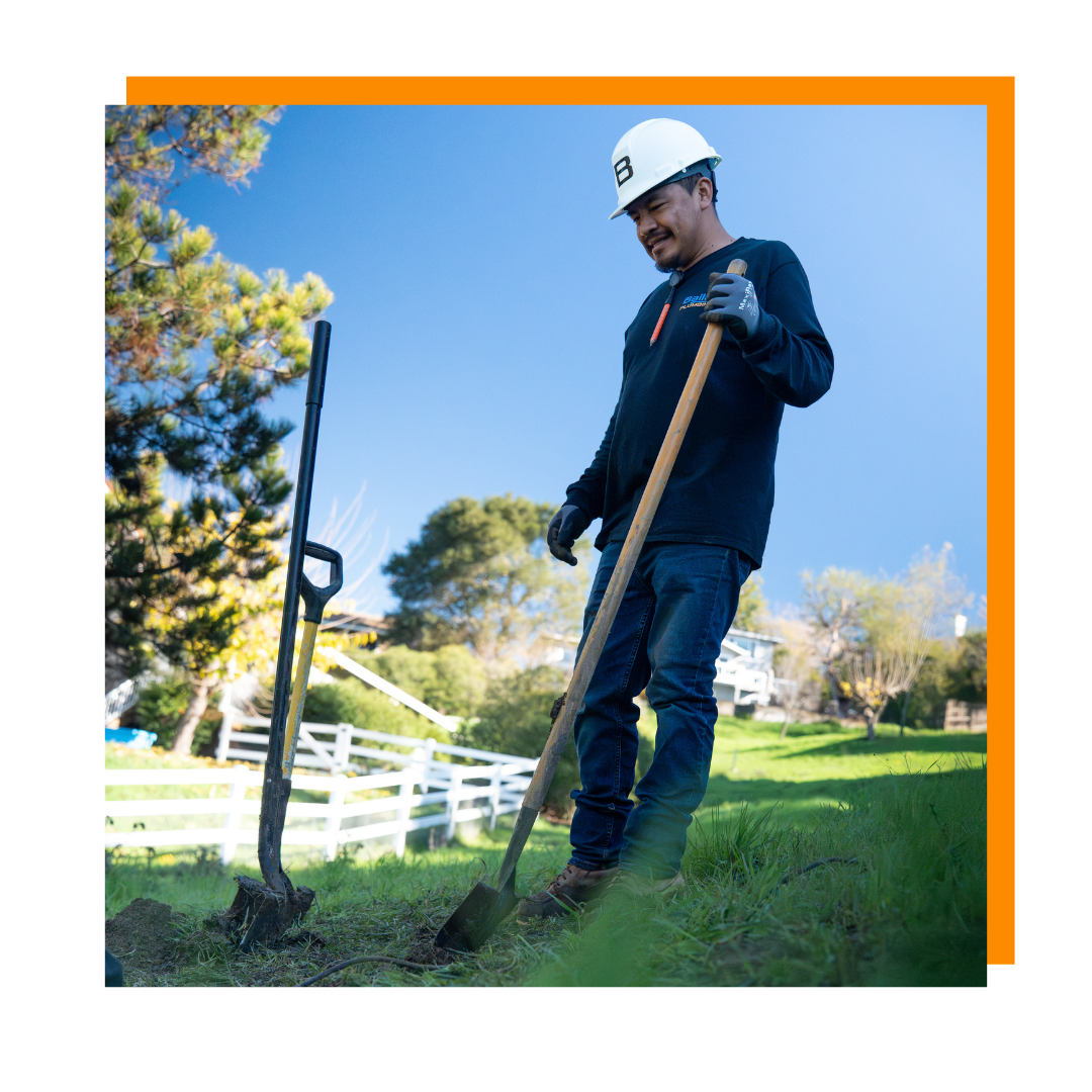 Bailey Plumbing worker using a shovel