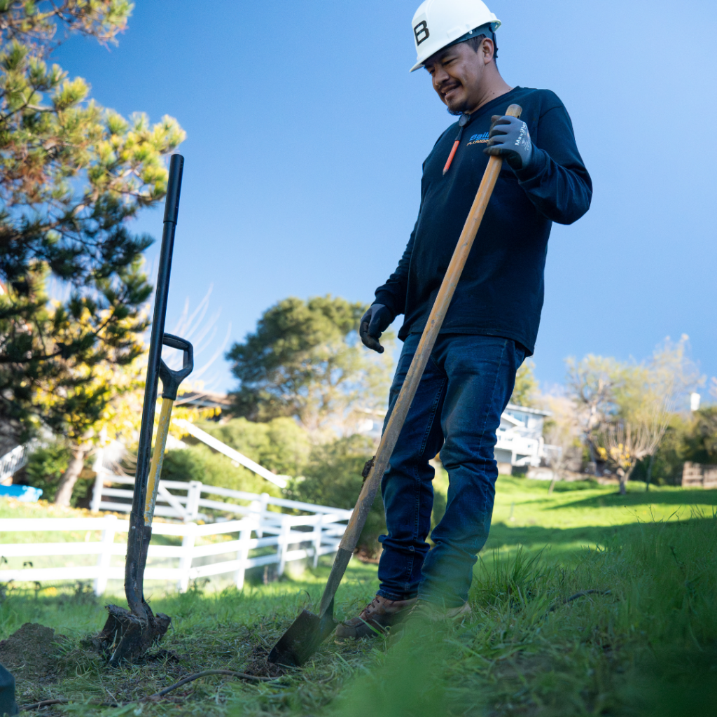 worker digging with shovel